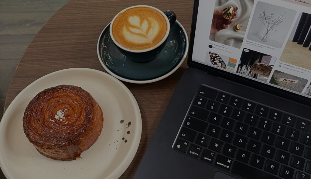 pastry coffee and laptop on a table